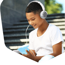 Young boy watching videos on a mobile phone outside