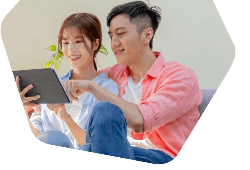 Young couple using their tablets at home