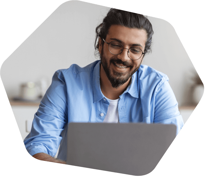Man smiling on a call on his laptop 