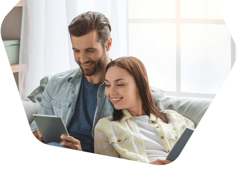 Young couple using their tablets at home